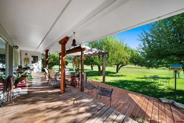 a view of a patio with a table and chairs
