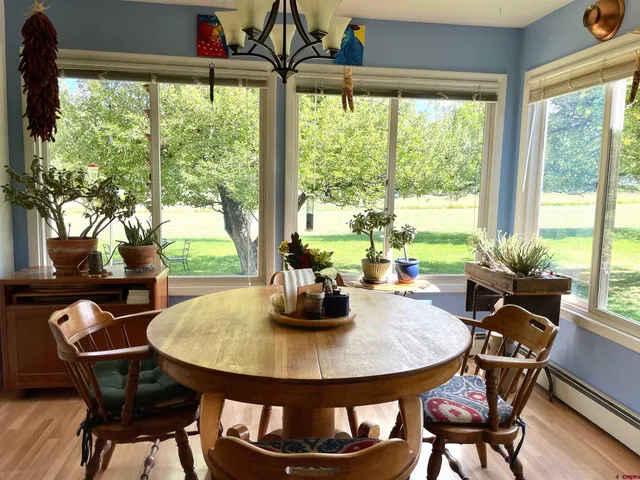 a dining room with furniture window and outside view