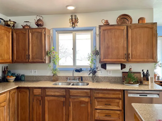 a kitchen with appliances cabinets and a sink