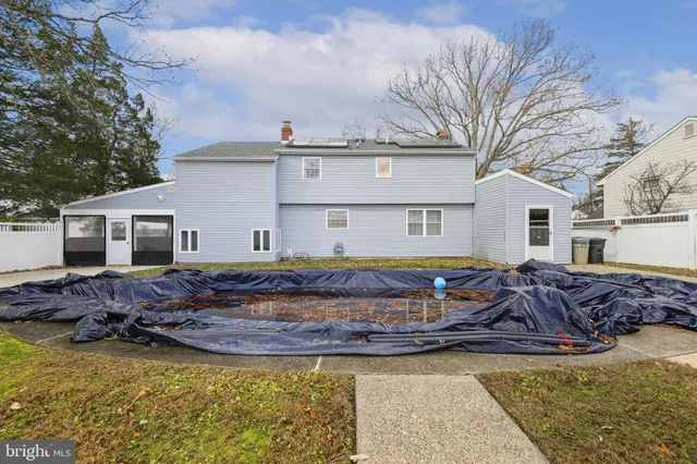 a view of a patio with table and chairs and floor to ceiling window