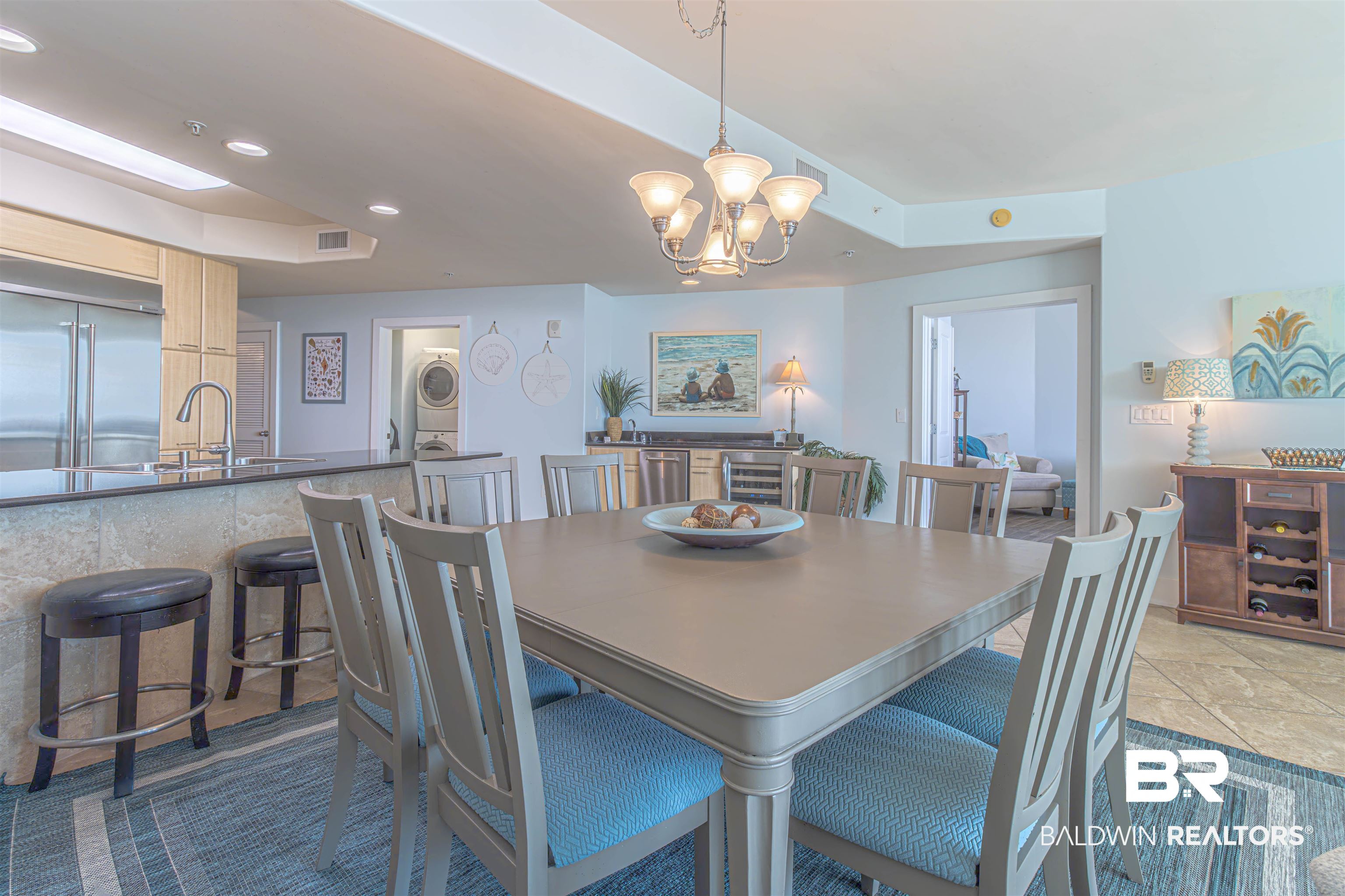 28107 Perdido Beach Boulevard, Unit D714 Orange Beach, AL 36561 - Photo 14 of 88 Dining room with beverage cooler, visible vents, an inviting chandelier, recessed lighting, and stacked washer / dryer
