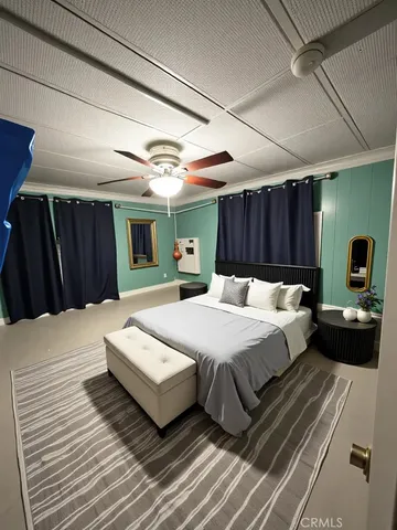 a large bed sitting in a bedroom next to a window