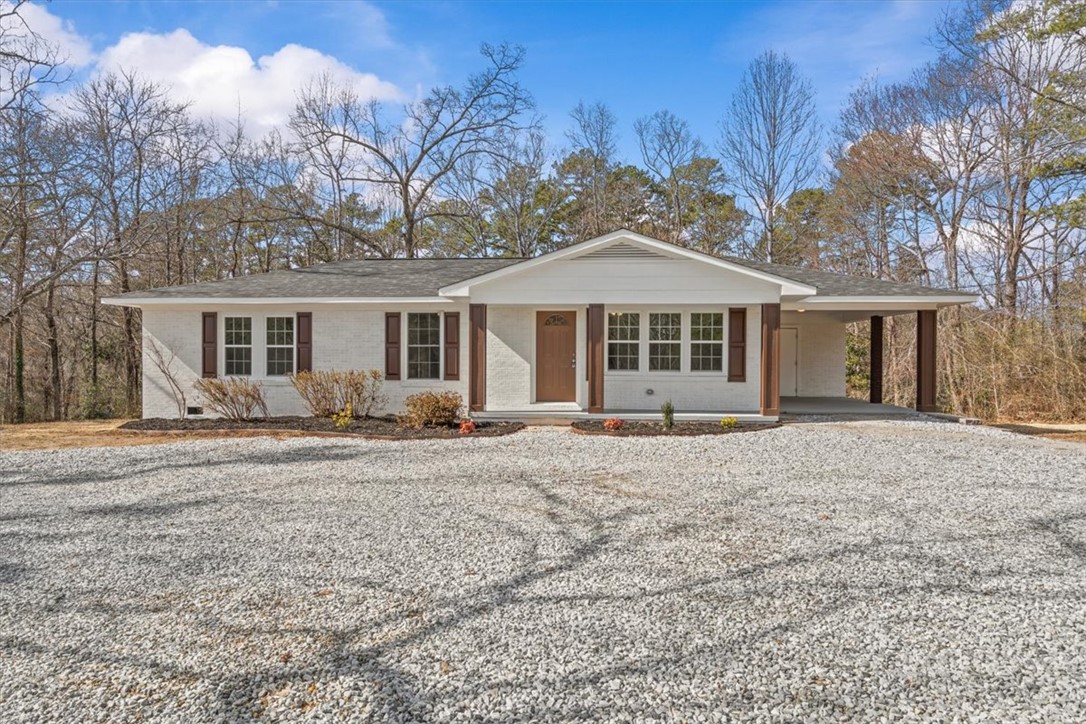 This charming home offers comfortable living with a spacious driveway and inviting entrance.