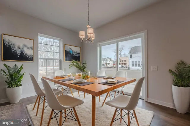 a dining room with furniture wooden floor and a chandelier
