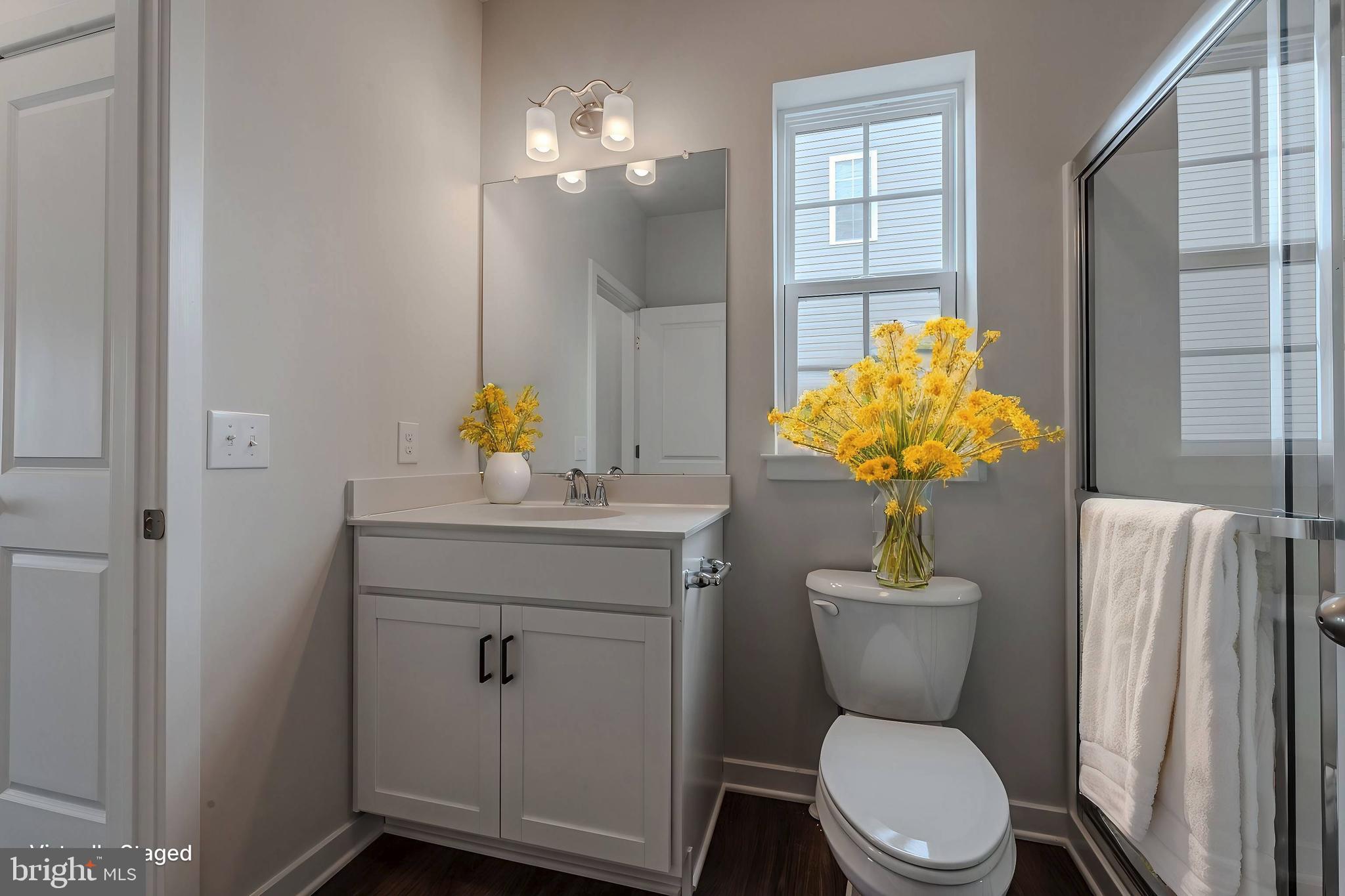 422 Bellflower Way, Unit CHALFONT Townsend, DE 19734 - Photo 15 of 21 a bathroom with a toilet sink and mirror