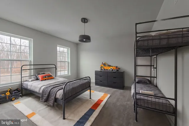 a bedroom with furniture and a window