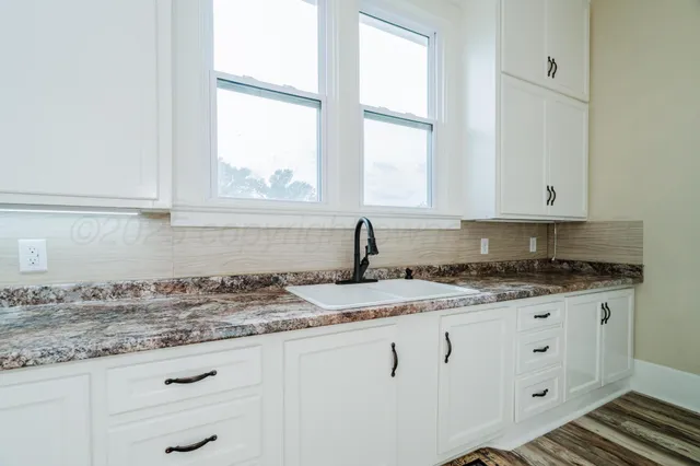 a white building with a table and chairs