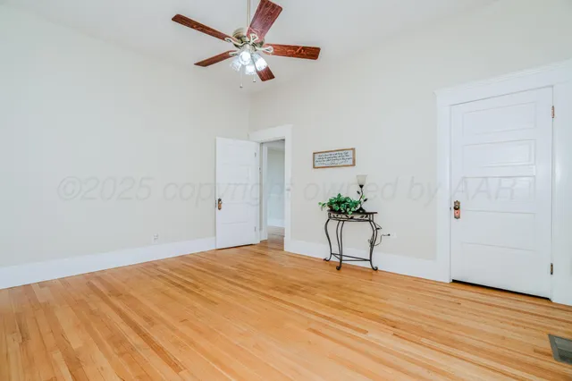 a view of wooden floor and closet in a room