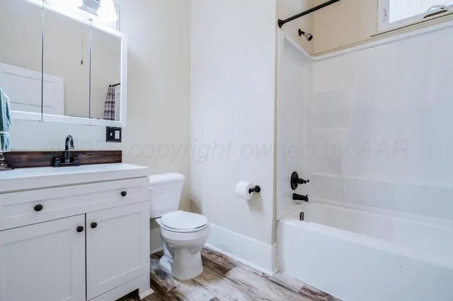 a view of a livingroom with wooden floor and a window
