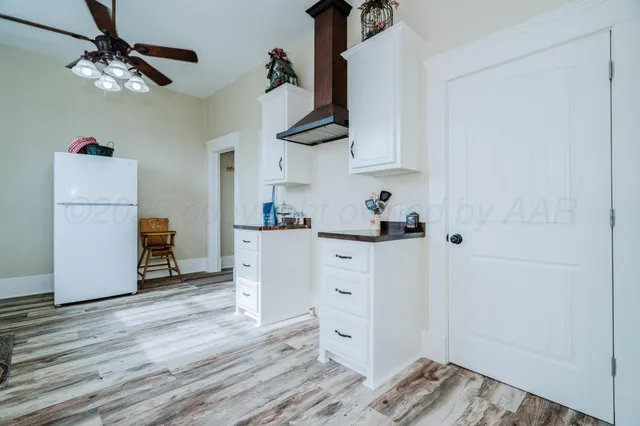 a view of a room with wooden floor and window