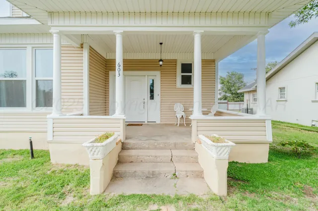 a kitchen with granite countertop white cabinets and a window