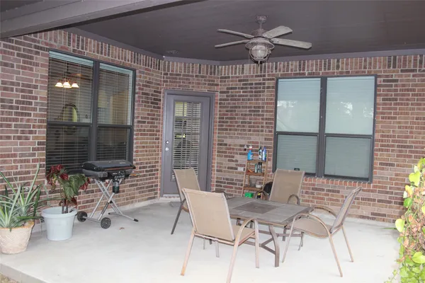 a view of a chairs and table in patio