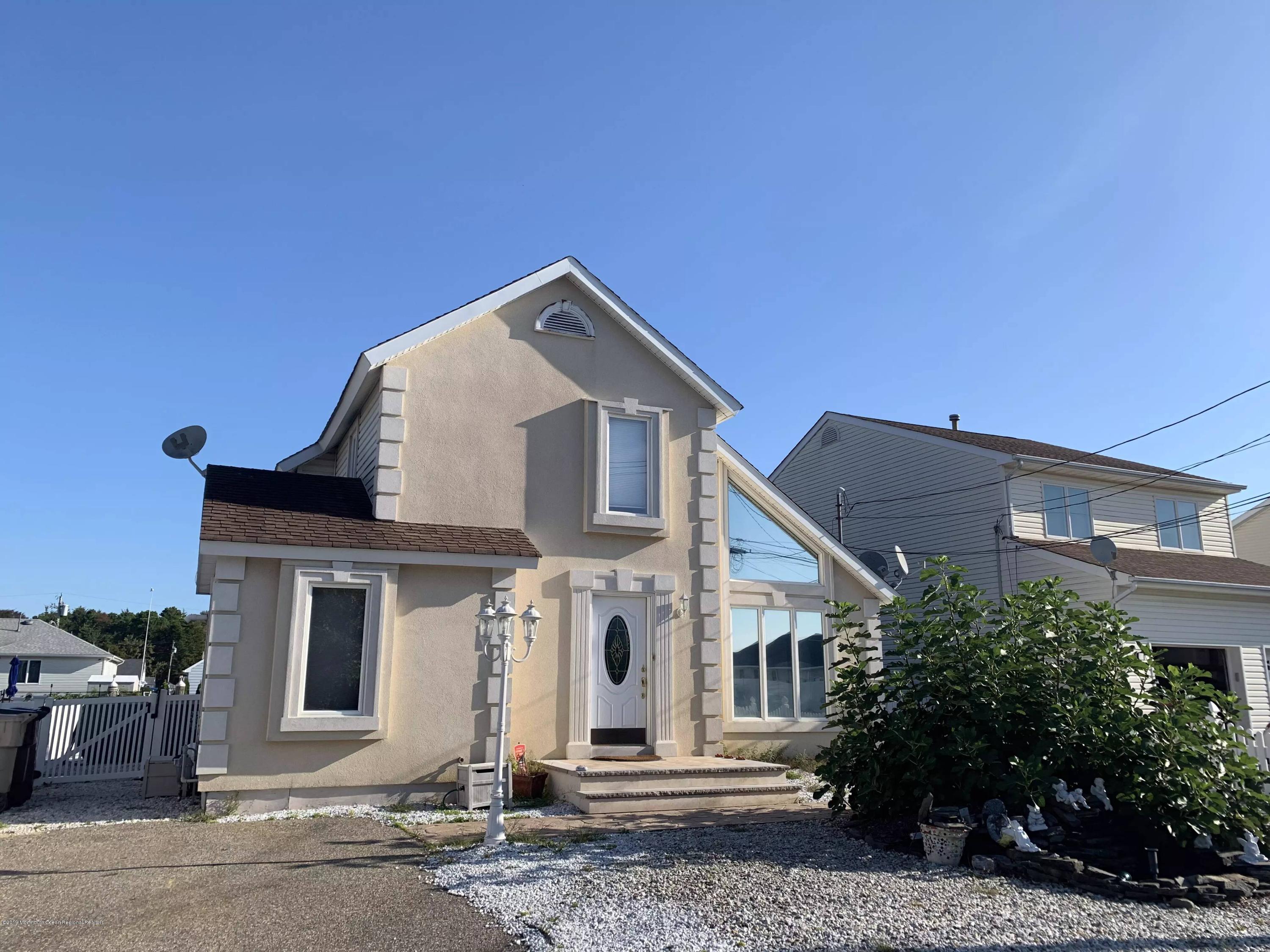 140 Cedar Run Road Bayville, NJ 08721 - Photo 1 of 18 a front view of a house with a yard