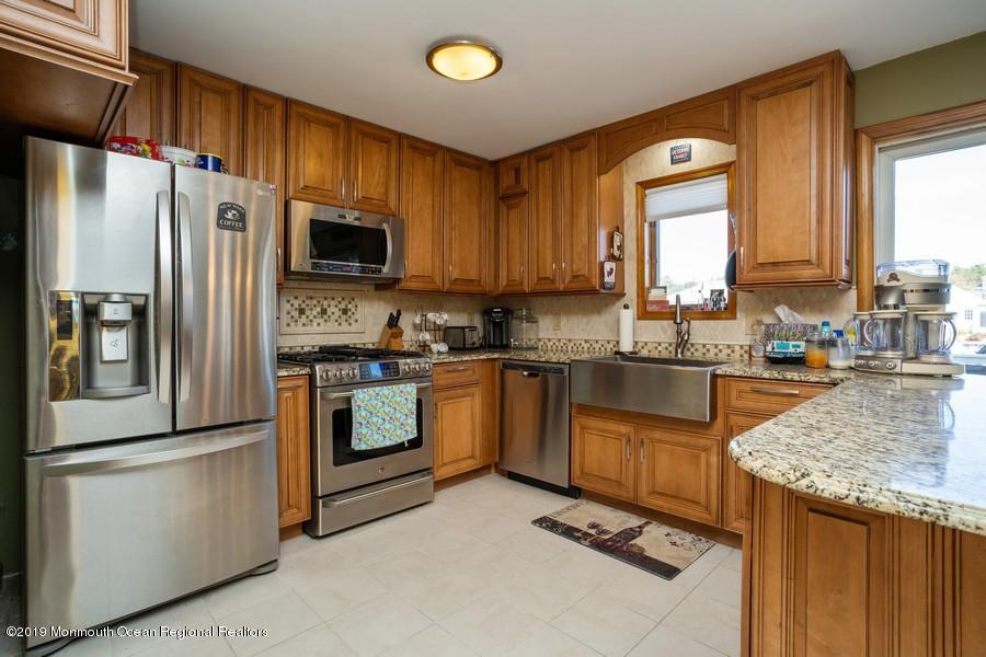 140 Cedar Run Road Bayville, NJ 08721 - Photo 3 of 18 a kitchen with granite countertop a refrigerator stove top oven and sink