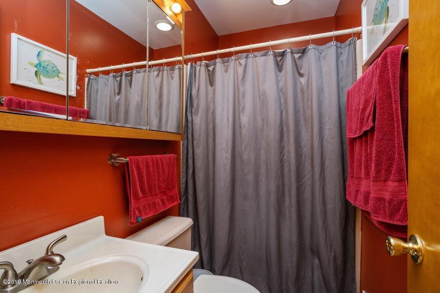 140 Cedar Run Road Bayville, NJ 08721 - Photo 7 of 18 a bathroom with a sink and a mirror