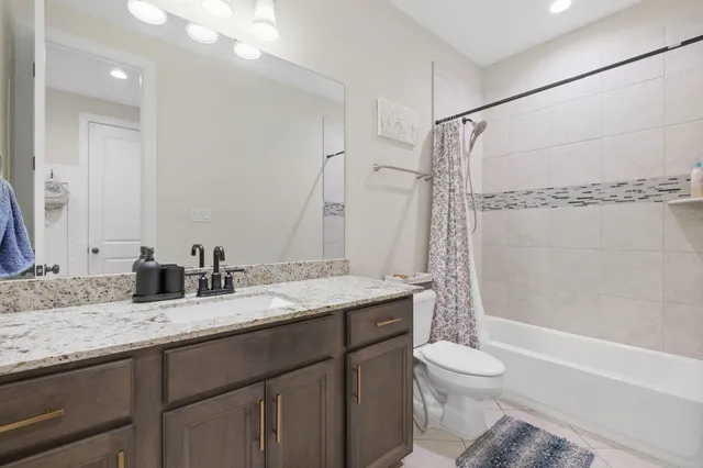 an empty room with a ceiling fan and window