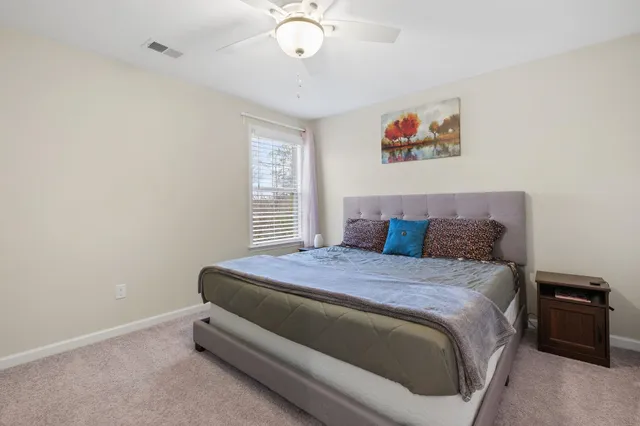 a bedroom with a bed and dresser