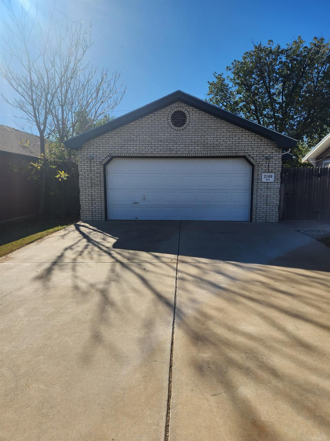 2109 21st Street, Unit 2 Lubbock, TX 79411 - Photo 1 of 21 a front view of a house with a yard and garage