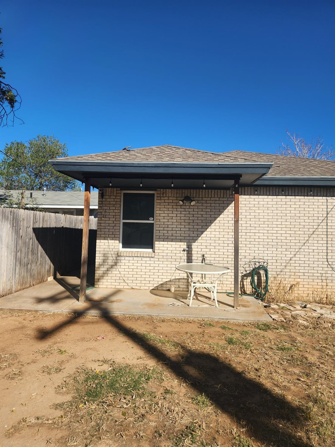 2109 21st Street, Unit 2 Lubbock, TX 79411 - Photo 20 of 21 a backyard of a house with table and chairs