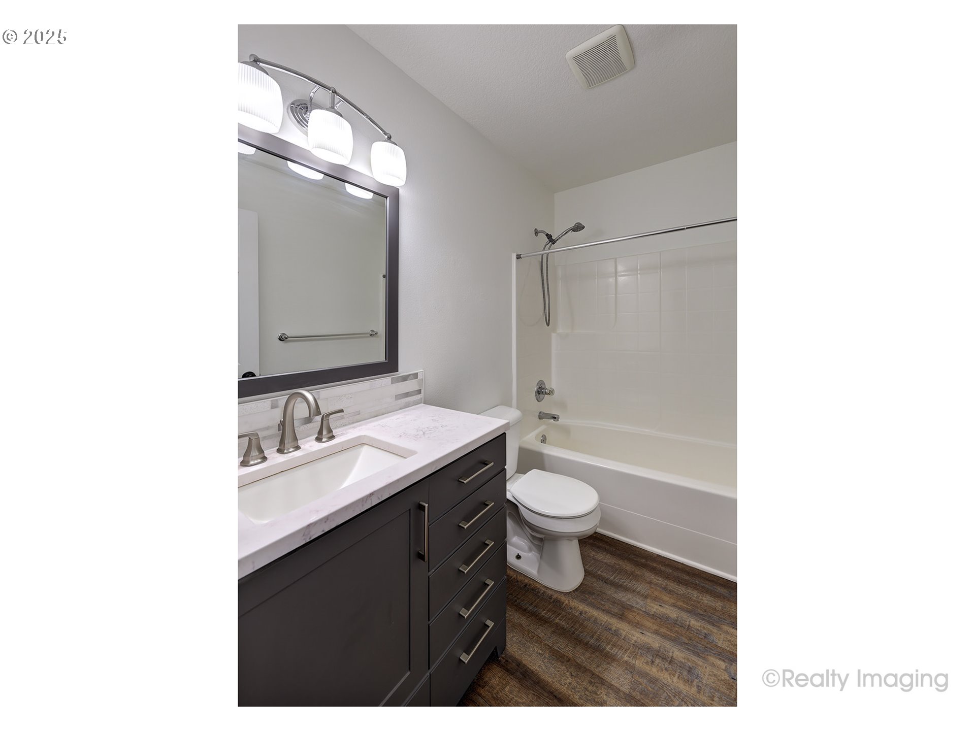 17893 Southwest Wakem Street Beaverton, OR 97003 - Photo 11 of 16 a bathroom with a granite countertop sink toilet a mirror and shower