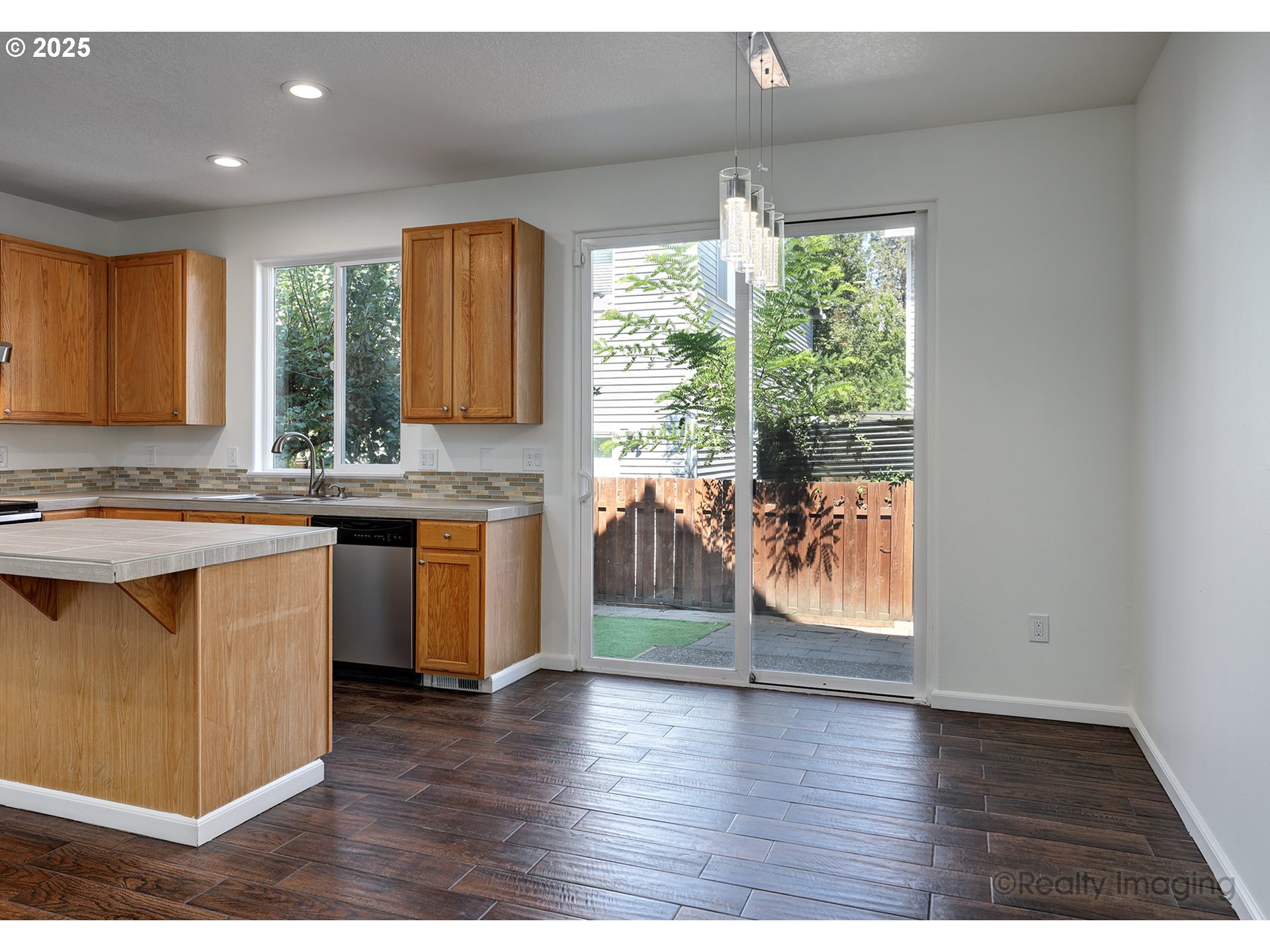 17893 Southwest Wakem Street Beaverton, OR 97003 - Photo 4 of 16 a open kitchen with granite countertop a stove top oven a sink with wooden cabinets
