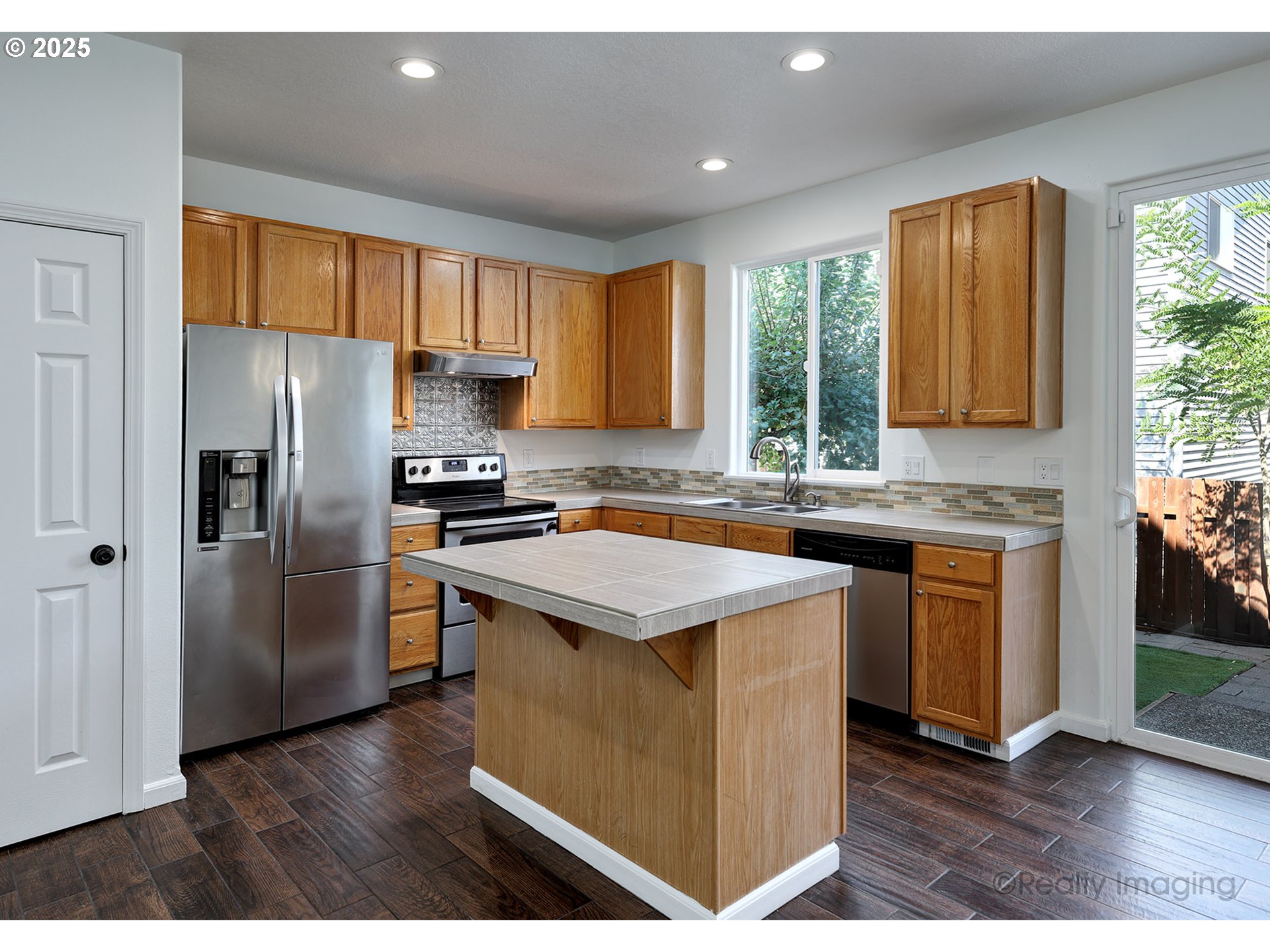 17893 Southwest Wakem Street Beaverton, OR 97003 - Photo 5 of 16 a kitchen with stainless steel appliances granite countertop a refrigerator a sink dishwasher a stove and a refrigerator