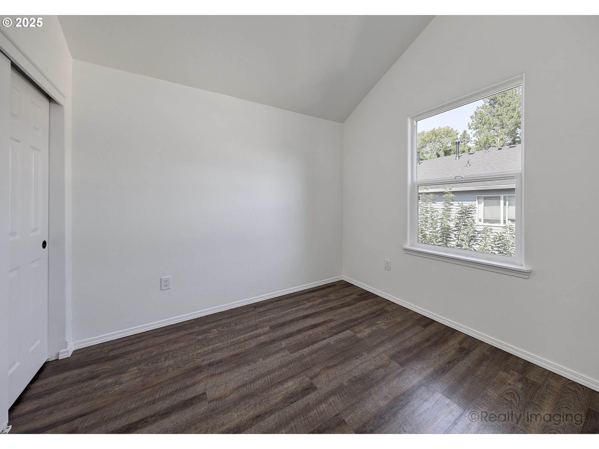 17893 Southwest Wakem Street Beaverton, OR 97003 - Photo 10 of 16 a view of an empty room with wooden floor and a window