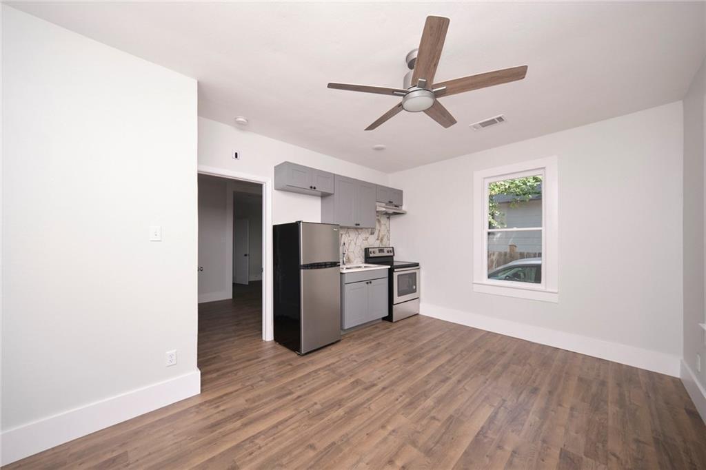 206 West 45th Street Austin, TX 78751 - Photo 2 of 6 a kitchen with a refrigerator and wooden floor
