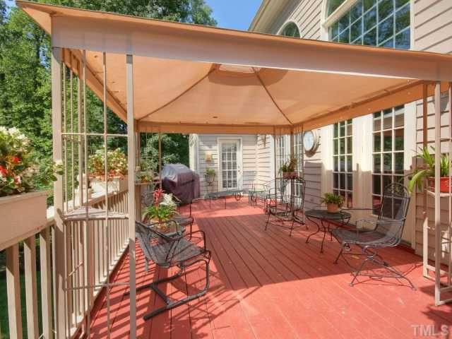 313 Carpathian Way Raleigh, NC 27615 - Photo 20 of 25 Enjoy those wonderful North Carolina summer and fall evenings on this large deck overlooking the lush back yard. Patio/Deck