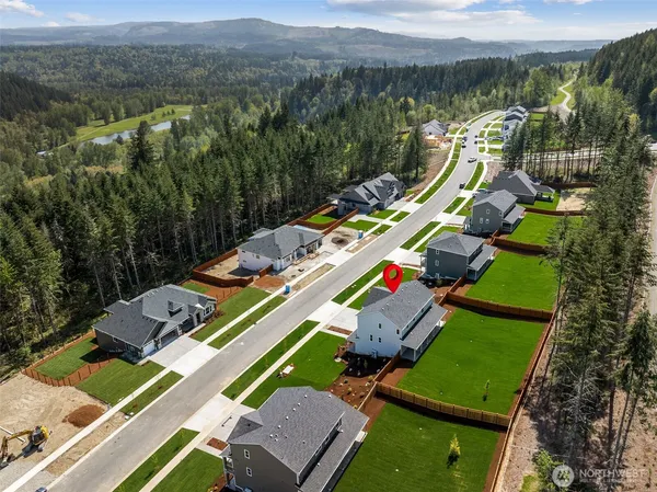 an aerial view of a house with a garden and lake view