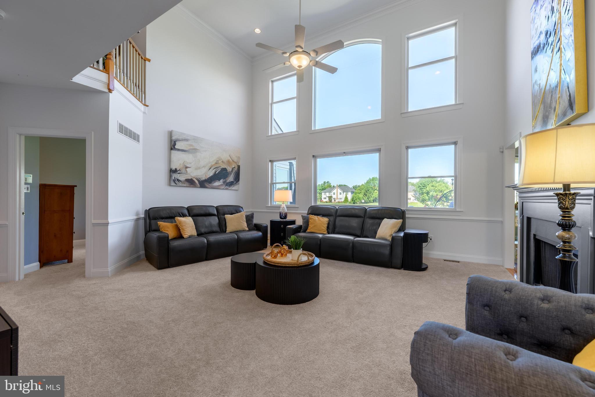 130 Augusta Drive Moorestown, NJ 08057 - Photo 5 of 36 a living room with furniture a chandelier and a flat screen tv