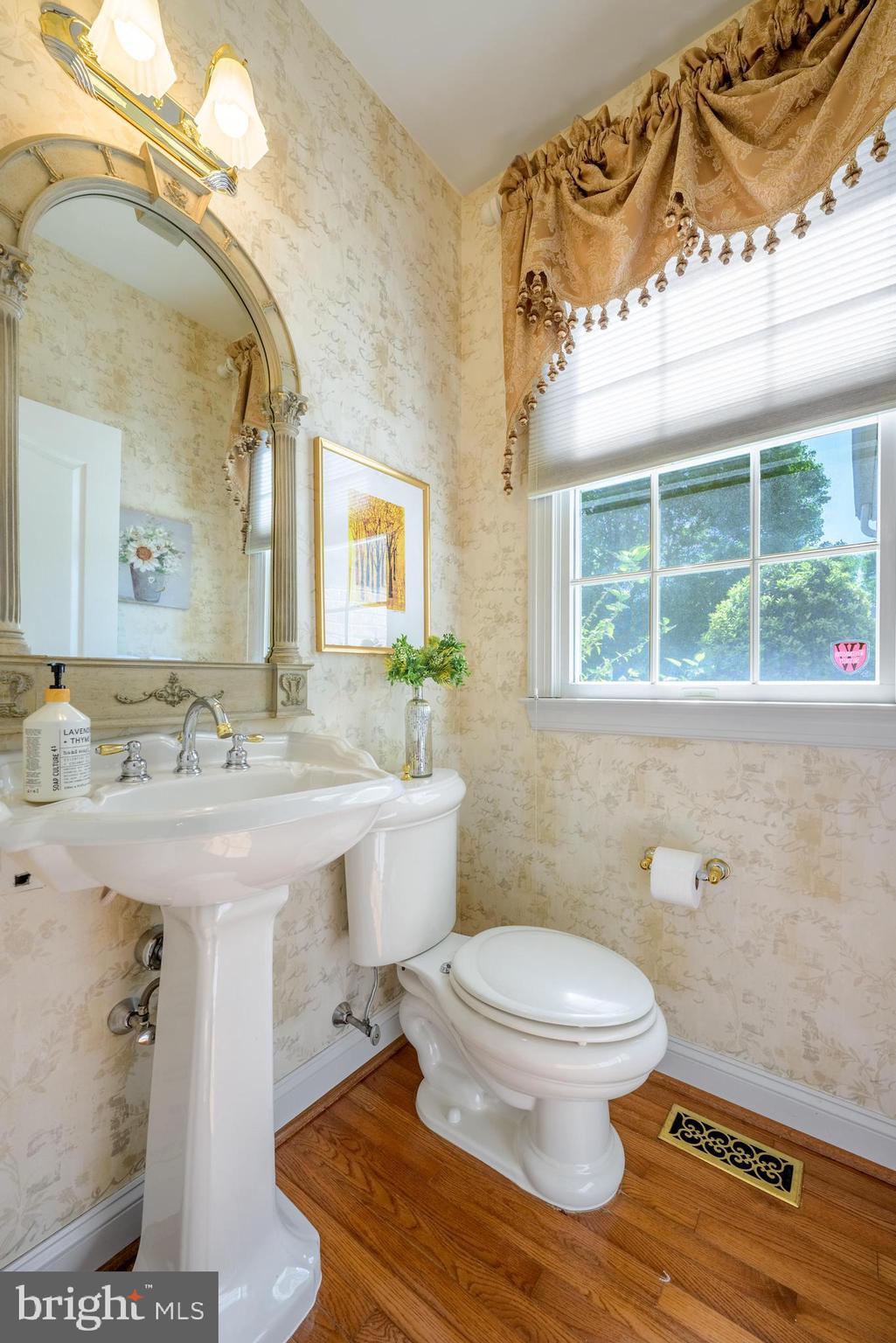 130 Augusta Drive Moorestown, NJ 08057 - Photo 8 of 36 a bathroom with a granite countertop sink a toilet a mirror and a shower