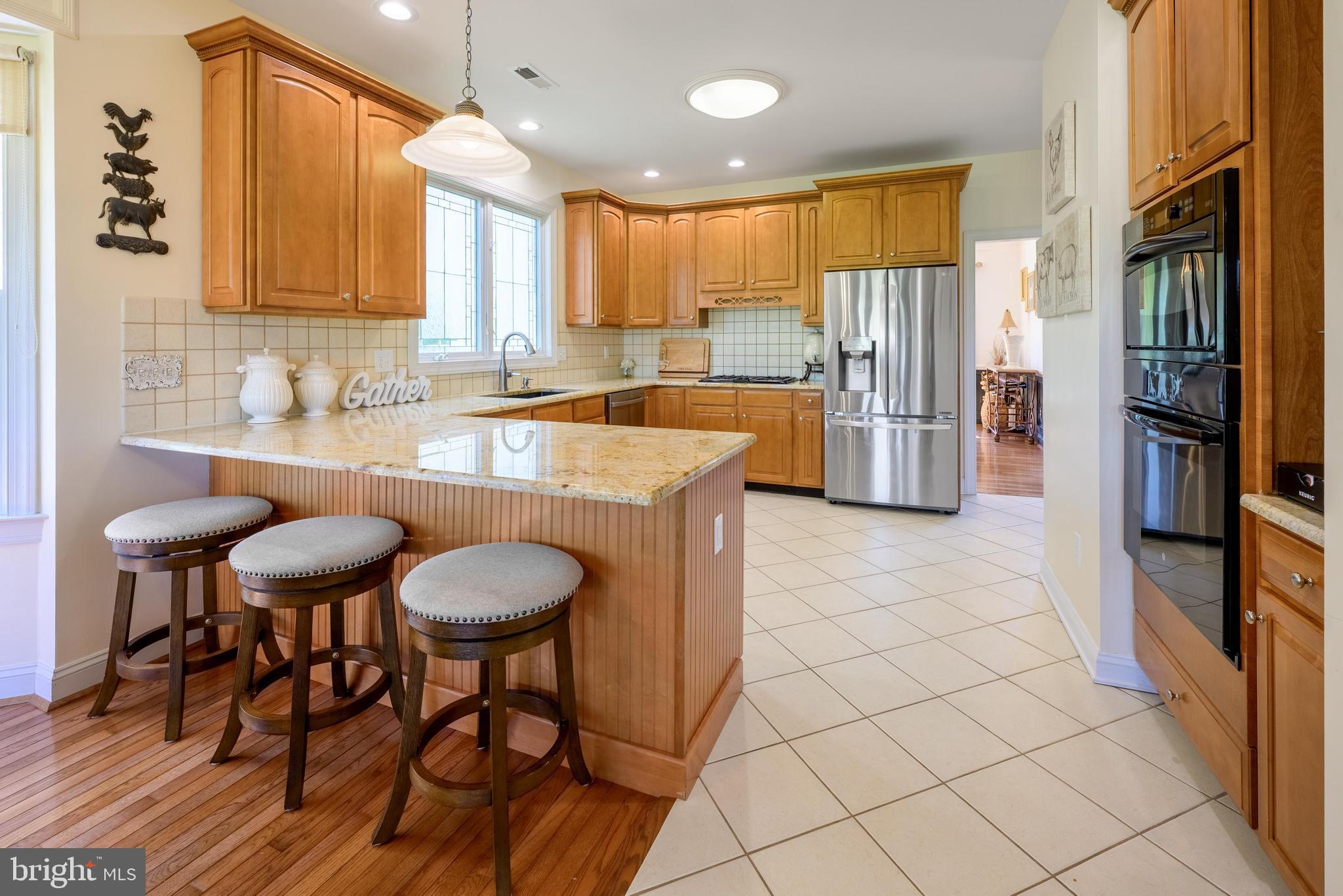 130 Augusta Drive Moorestown, NJ 08057 - Photo 9 of 36 a kitchen with stainless steel appliances granite countertop a stove a sink and a refrigerator