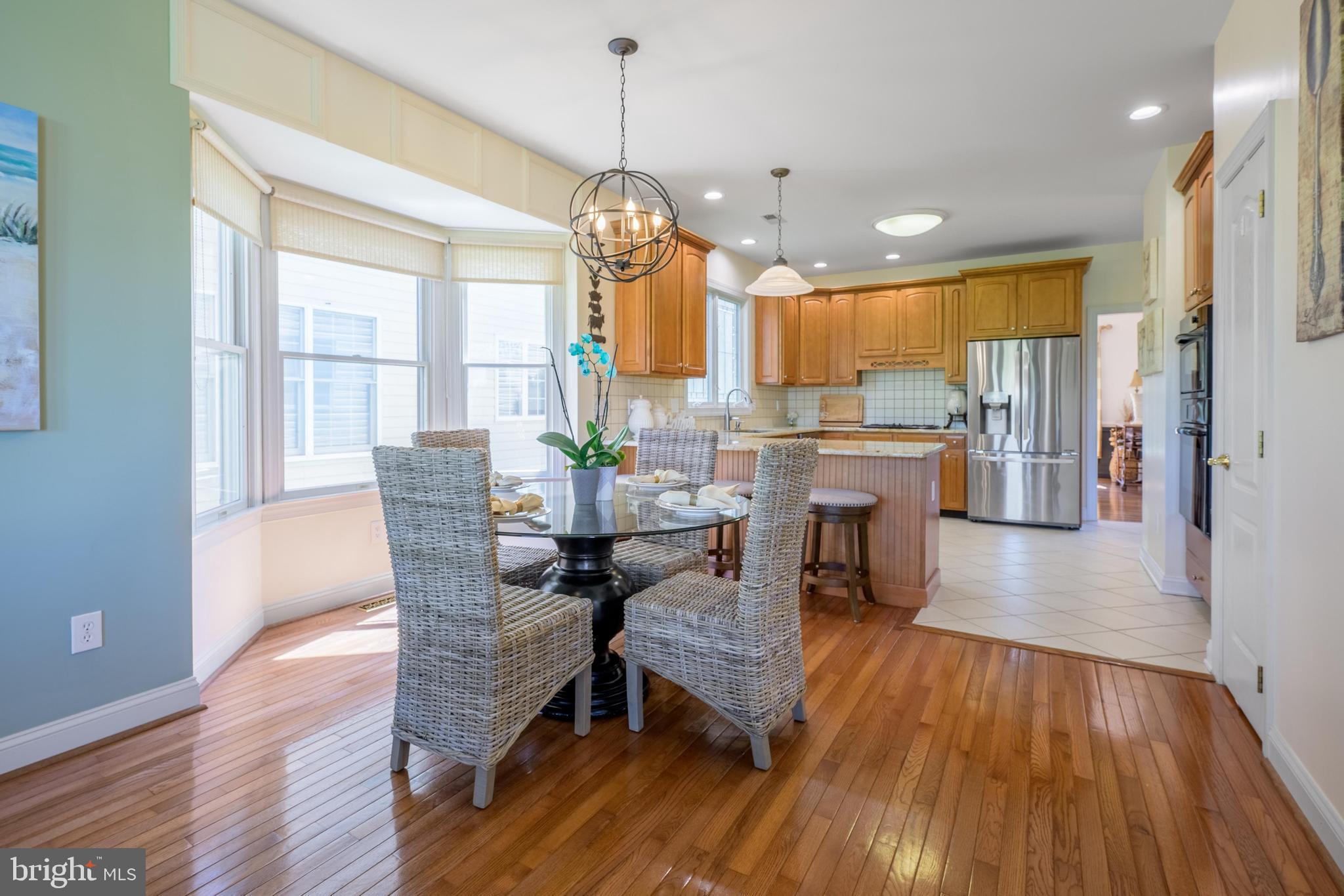130 Augusta Drive Moorestown, NJ 08057 - Photo 10 of 36 a view of a dining room and livingroom with furniture wooden floor a chandelier