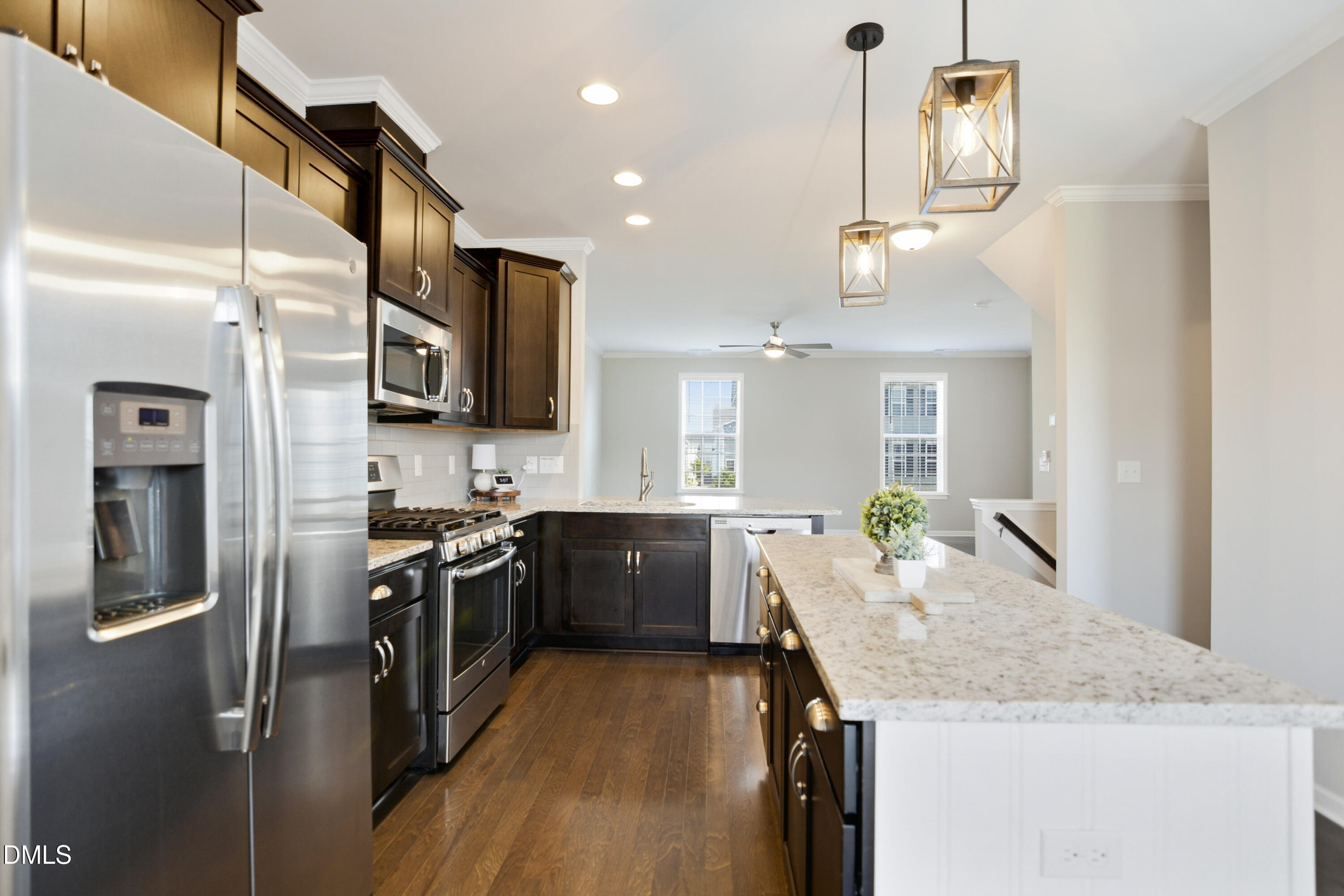 5916 Giddings Street Raleigh, NC 27616 - Photo 11 of 49 a large kitchen with granite countertop a sink and stainless steel appliances