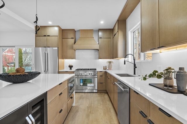 a living room with furniture a table and kitchen view