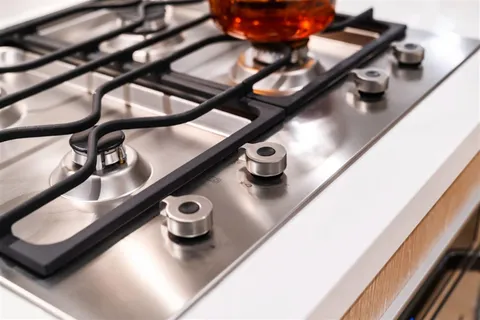 a kitchen with a sink a stove and cabinets