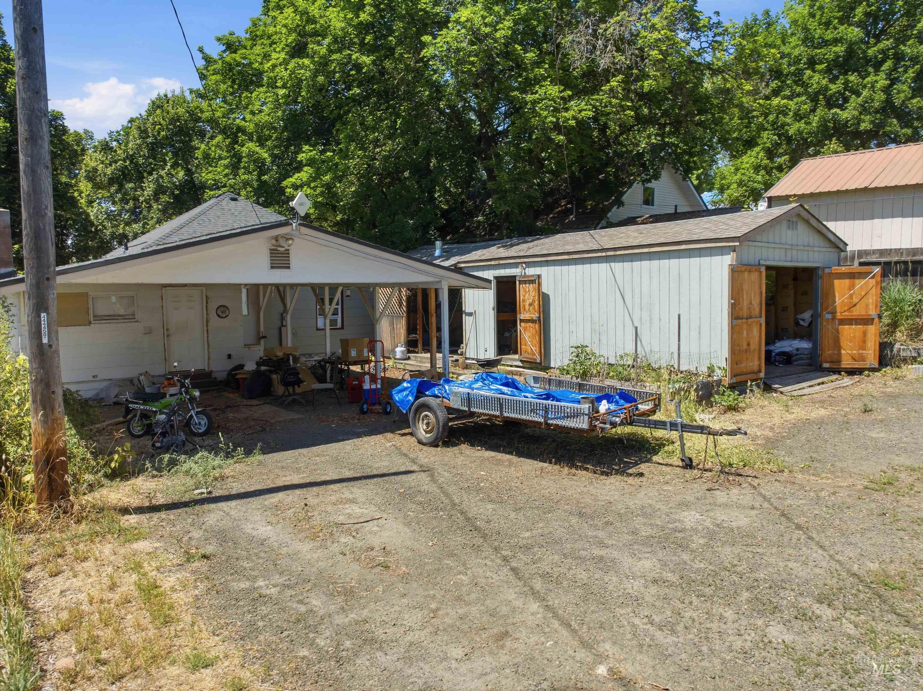735 Oak Street Potlatch, ID 83855 - Photo 14 of 30 Carport entry with an adjacent shed featuring dual wooden doors