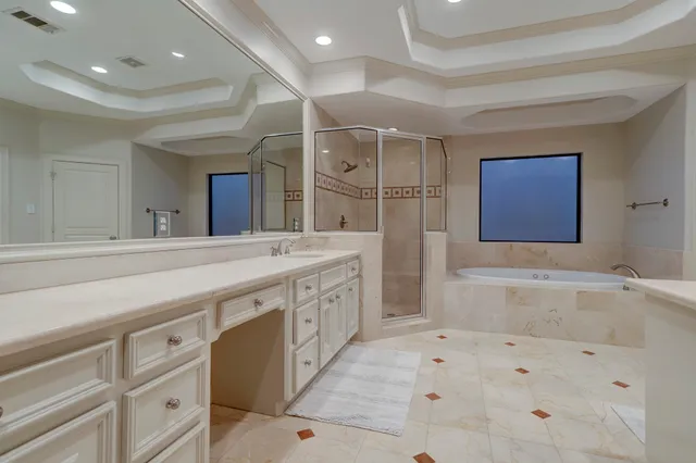 a spacious bathroom with a double vanity sink a mirror and a bathtub