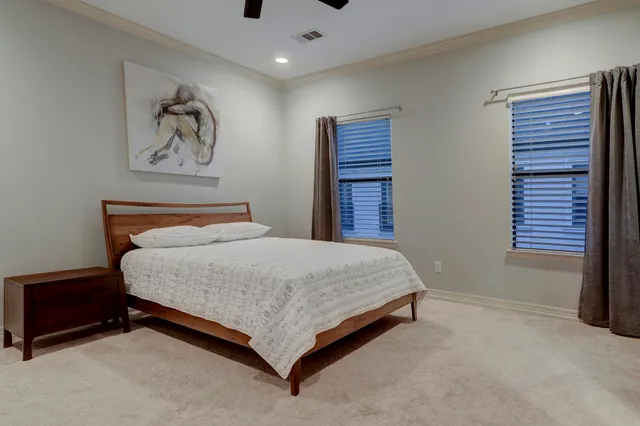 a bedroom with a bed and a painting on the wall
