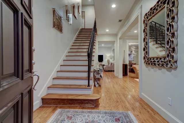 a view of entryway and hall with wooden floor