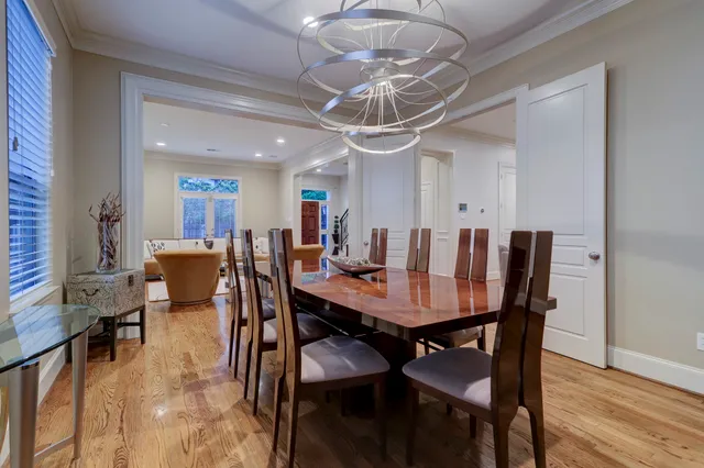 a view of a dining room with furniture wooden floor and chandelier