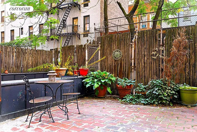 a backyard of a house with a garden and outdoor seating