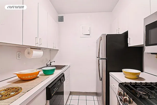 a kitchen with stainless steel appliances granite countertop a refrigerator and a stove