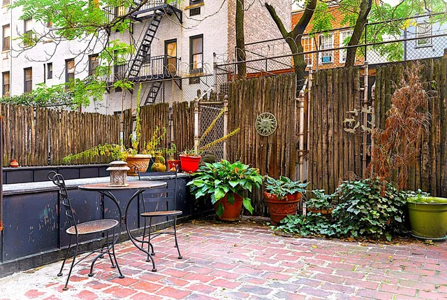 a backyard of a house with a garden and plants