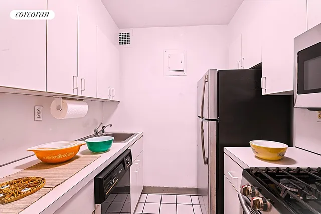 a kitchen with stainless steel appliances granite countertop a sink and a stove