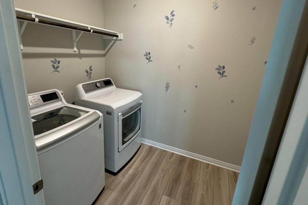 12604 Dairywork Road Buda, TX 78610 - Photo 10 of 20 A well-organized laundry area featuring contemporary appliances and ample shelving for household essentials.