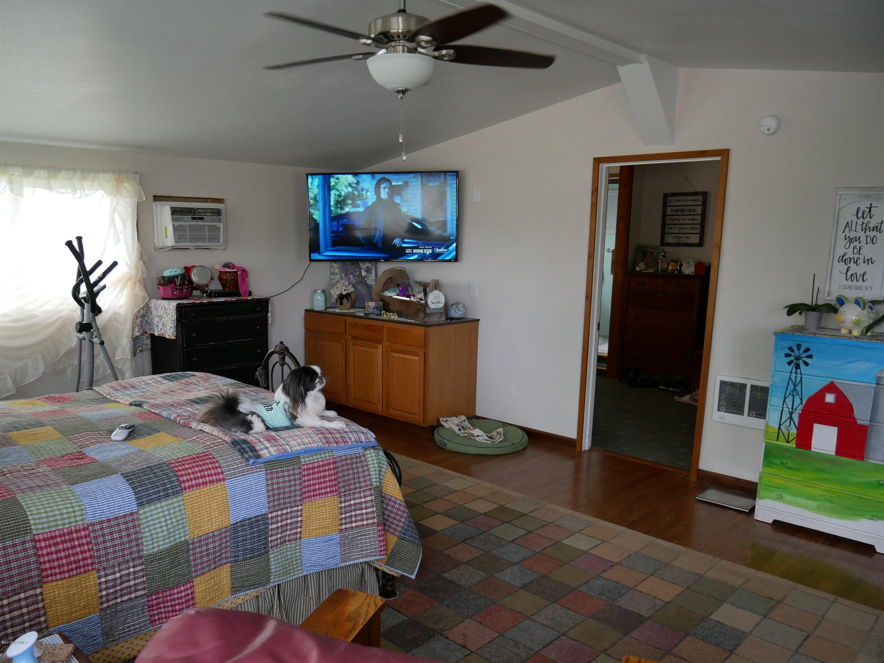 1001 Albro Road North Prosser, WA 99350 - Photo 5 of 19 a bedroom with a bed and wooden floor