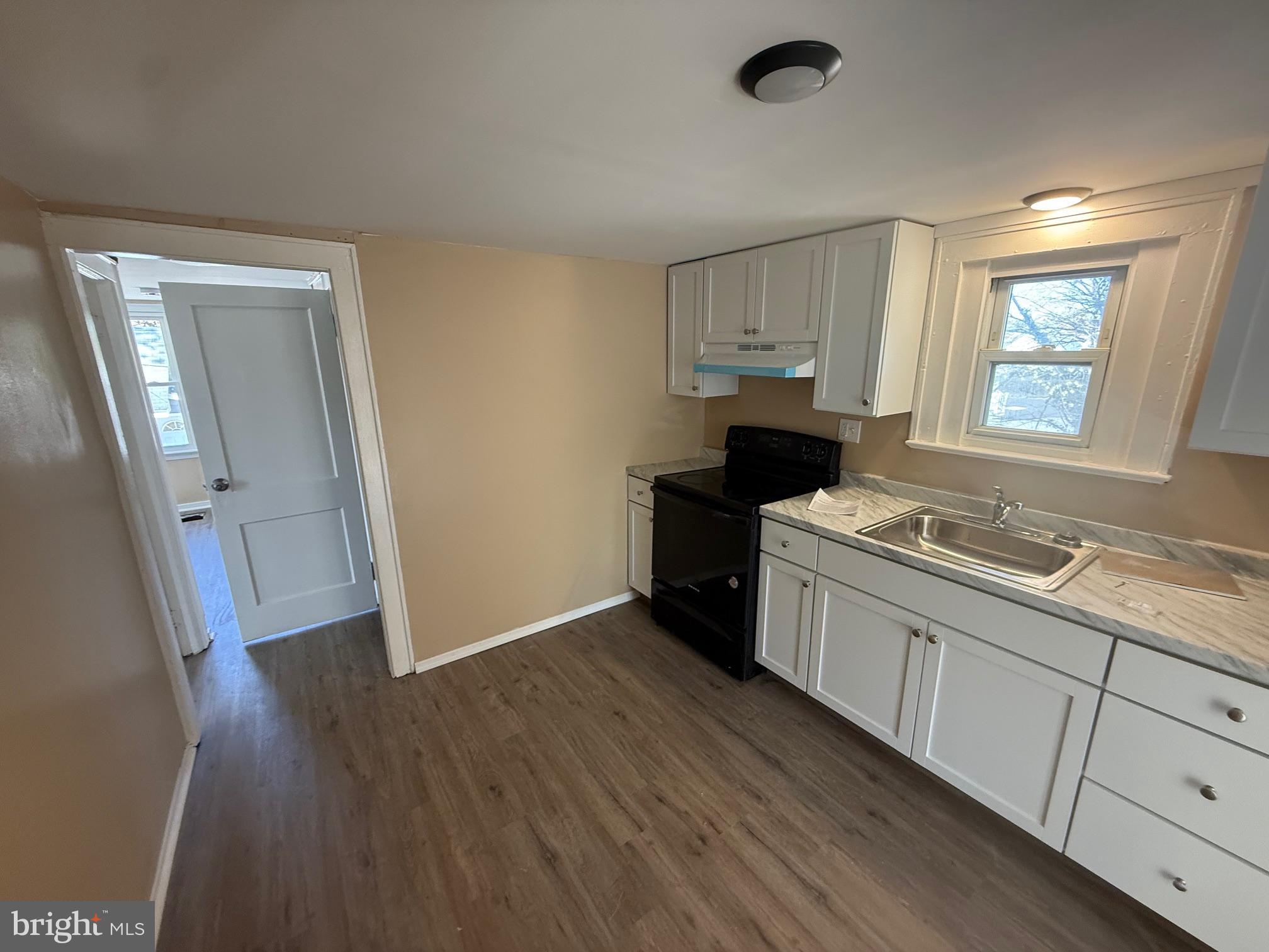 1453 South Main Road, Unit 5 Vineland, NJ 08360 - Photo 2 of 7 a kitchen with granite countertop a sink cabinets and wooden floor