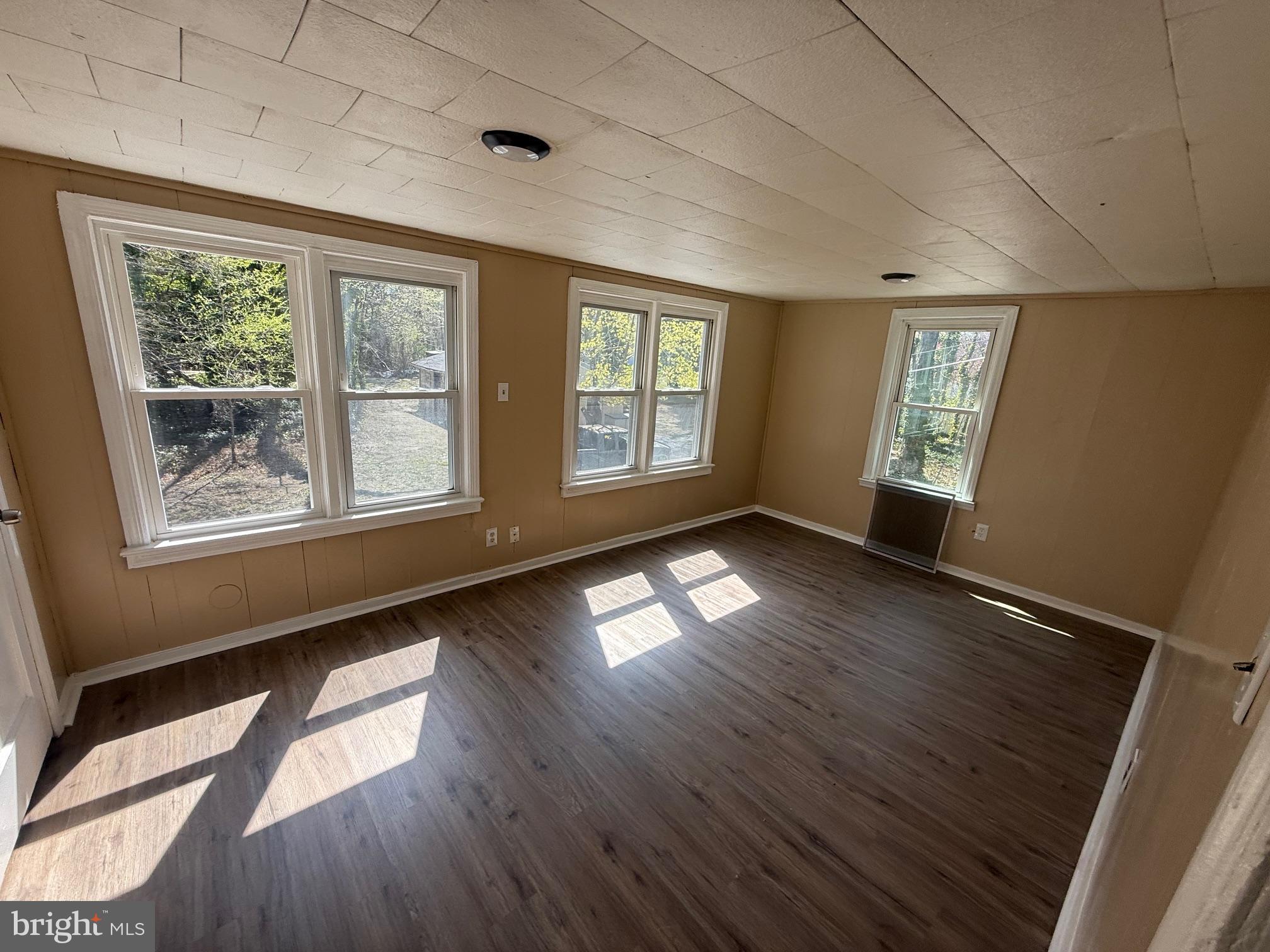 1453 South Main Road, Unit 5 Vineland, NJ 08360 - Photo 3 of 7 a view of empty room with wooden floor and fan